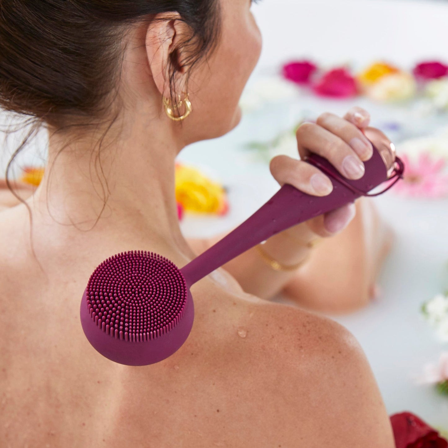 hover-image? Woman using PMD Clean Body in berry to massage her back