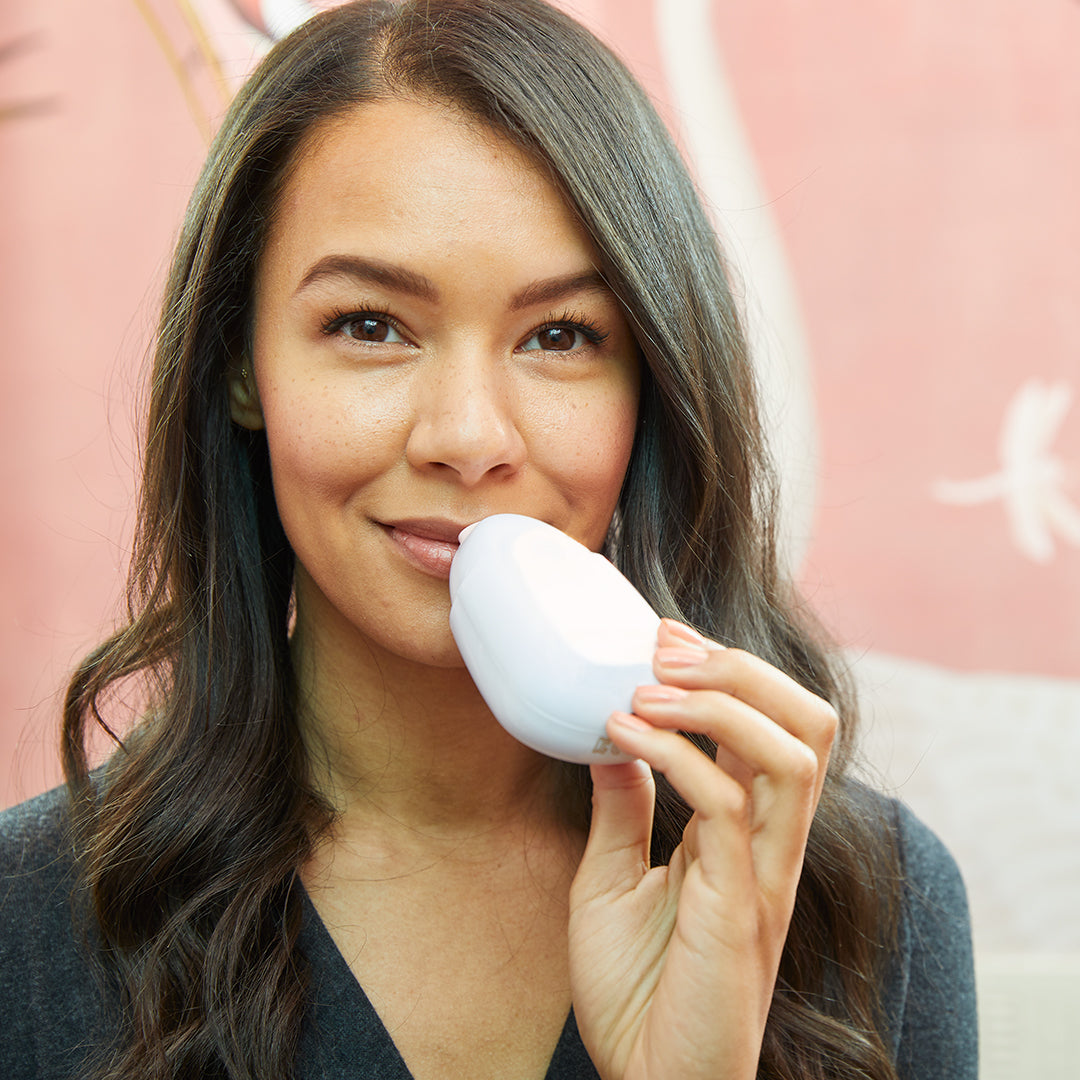 hover-image?Woman using PMD Kiss to plump her lips