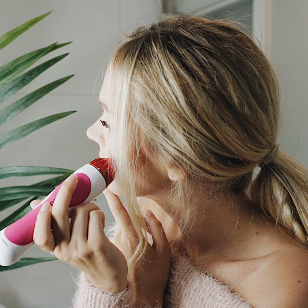 1001-Pink?Woman using Personal Microderm Classic in pink to do an at home microdermabrasion treatment