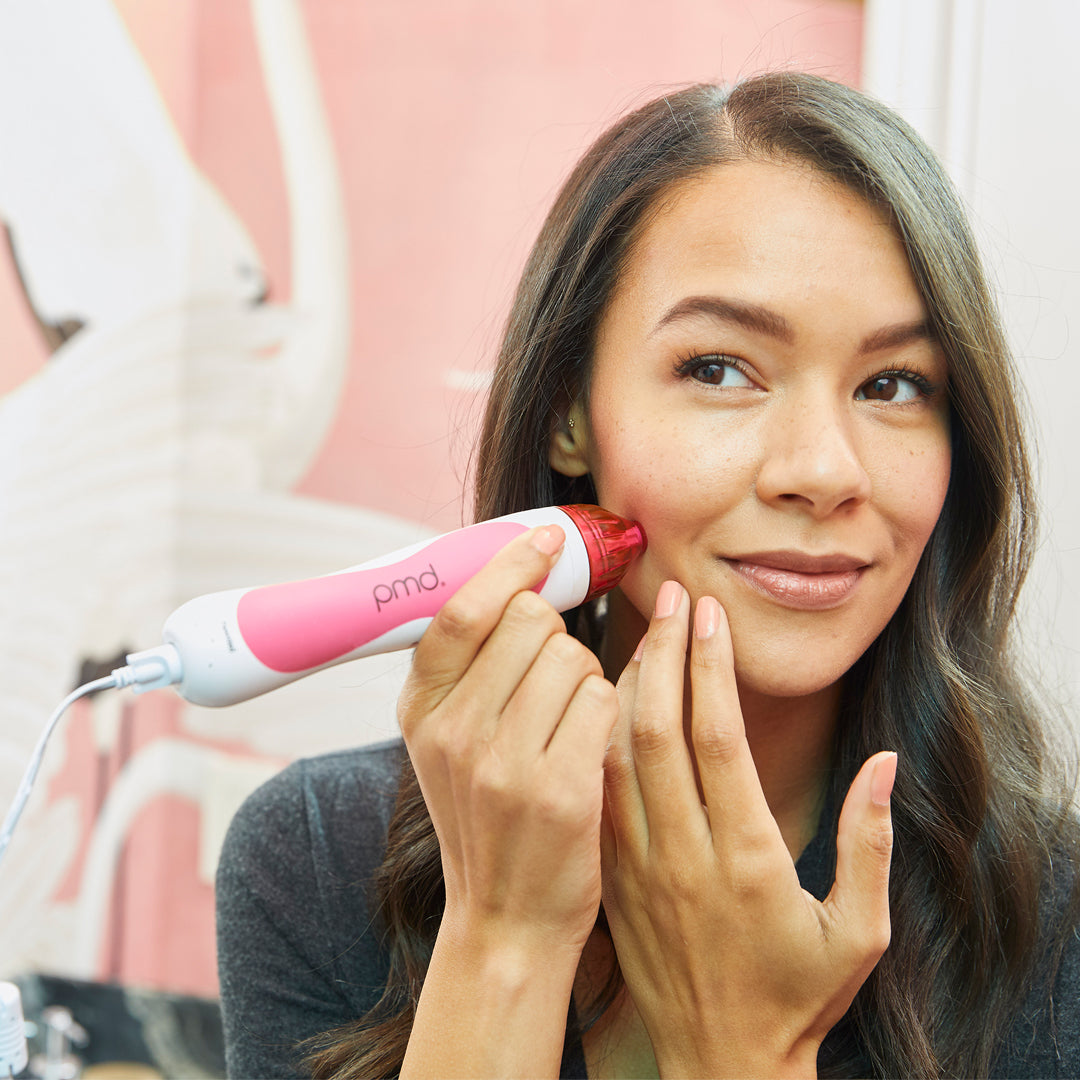 1001-Pink?Woman using Personal Microderm Classic in pink to do an at home microdermabrasion treatment