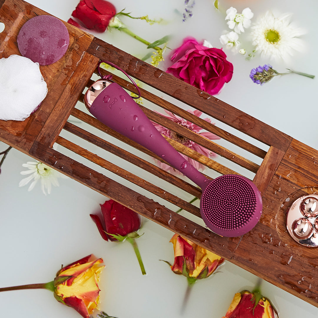 4003-Berry?PMD Clean Body in berry on bath tray surrounded by flowers