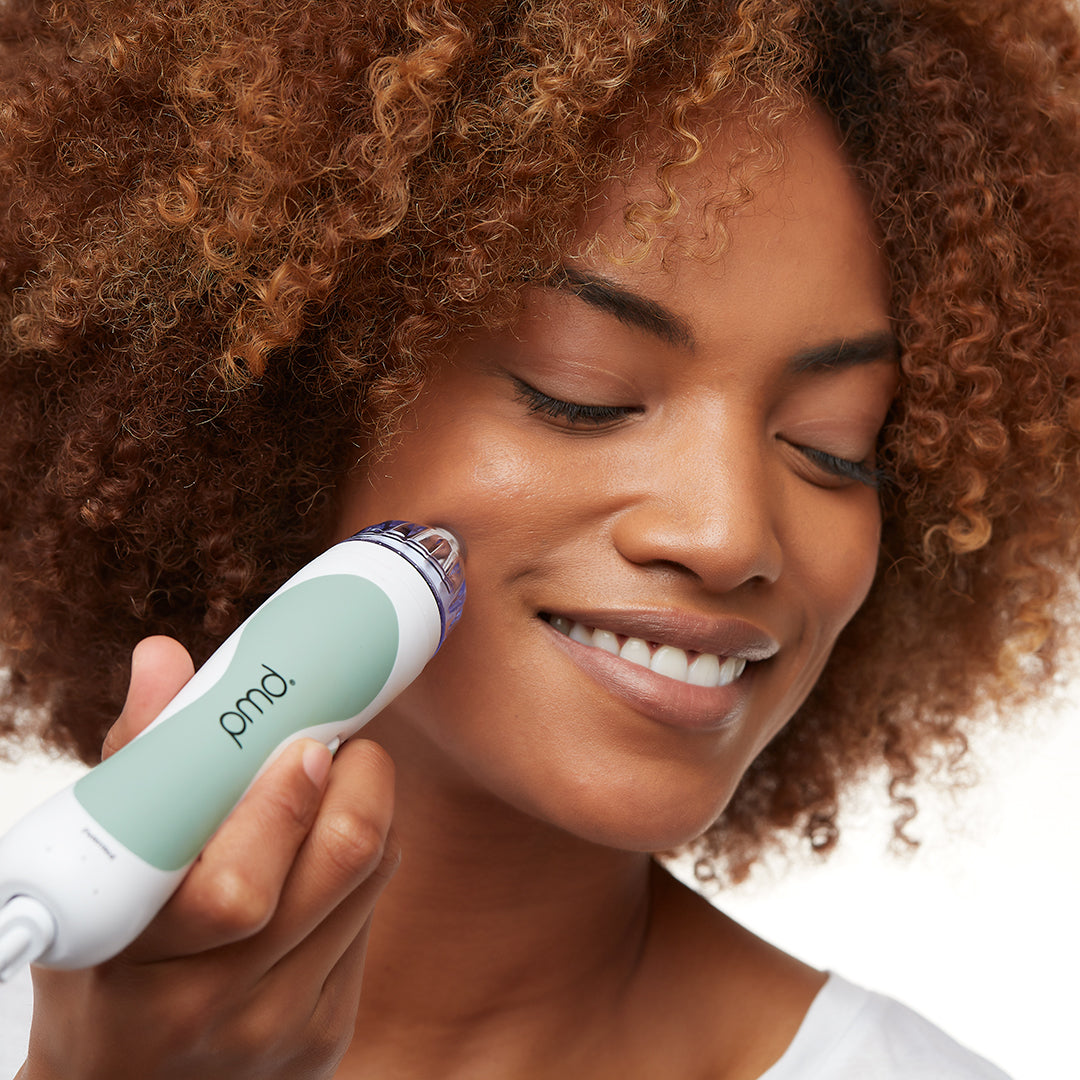 1002?Woman using Personal Microderm Classic in grey to do an at home microdermabrasion treatment